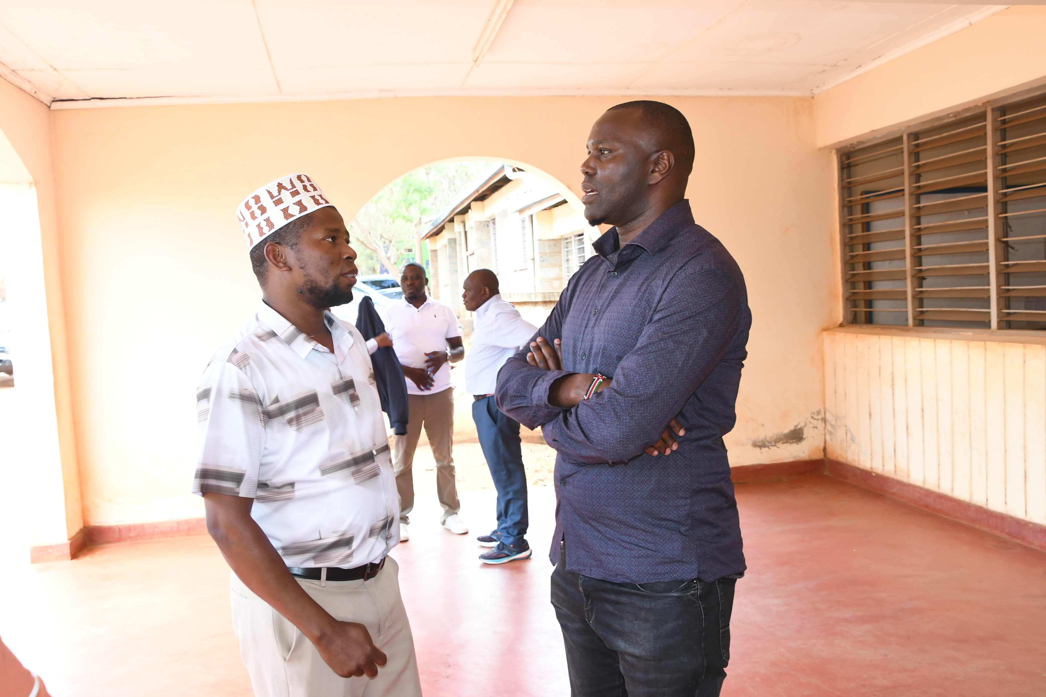 George Mosiori, a board member of the WCTF sharing a moment with one of the participants at Voi subcounty headquarters shortly after the stakeholder engagement session. 